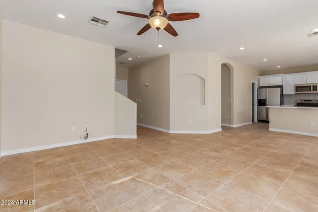 a view of a kitchen with a sink and a refrigerator