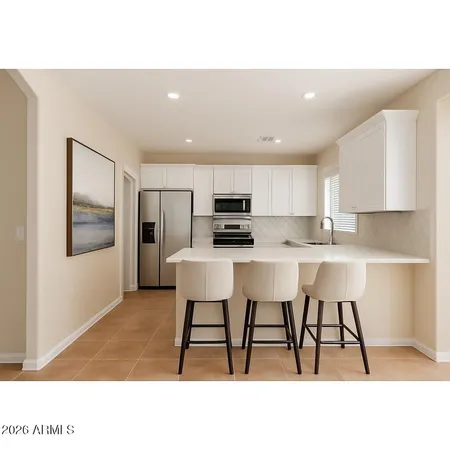 a kitchen with a table chairs refrigerator and cabinets