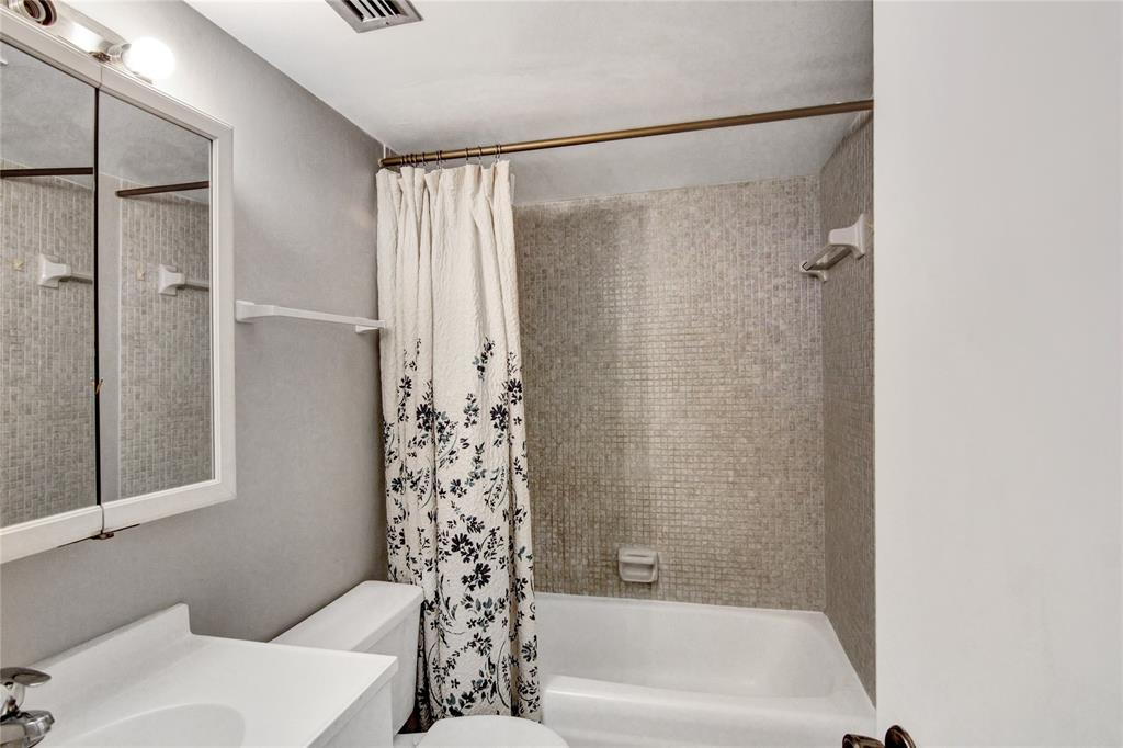 4500 North Federal Highway, Unit 158G Lighthouse Point, FL 33064 - Photo 11 of 36 a bathroom with a bathtub and a shower
