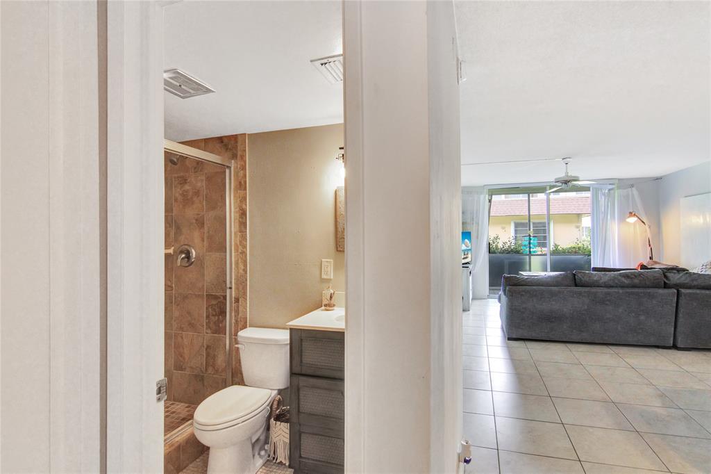 4500 North Federal Highway, Unit 158G Lighthouse Point, FL 33064 - Photo 15 of 36 a bathroom with a granite countertop bathtub shower sink and toilet