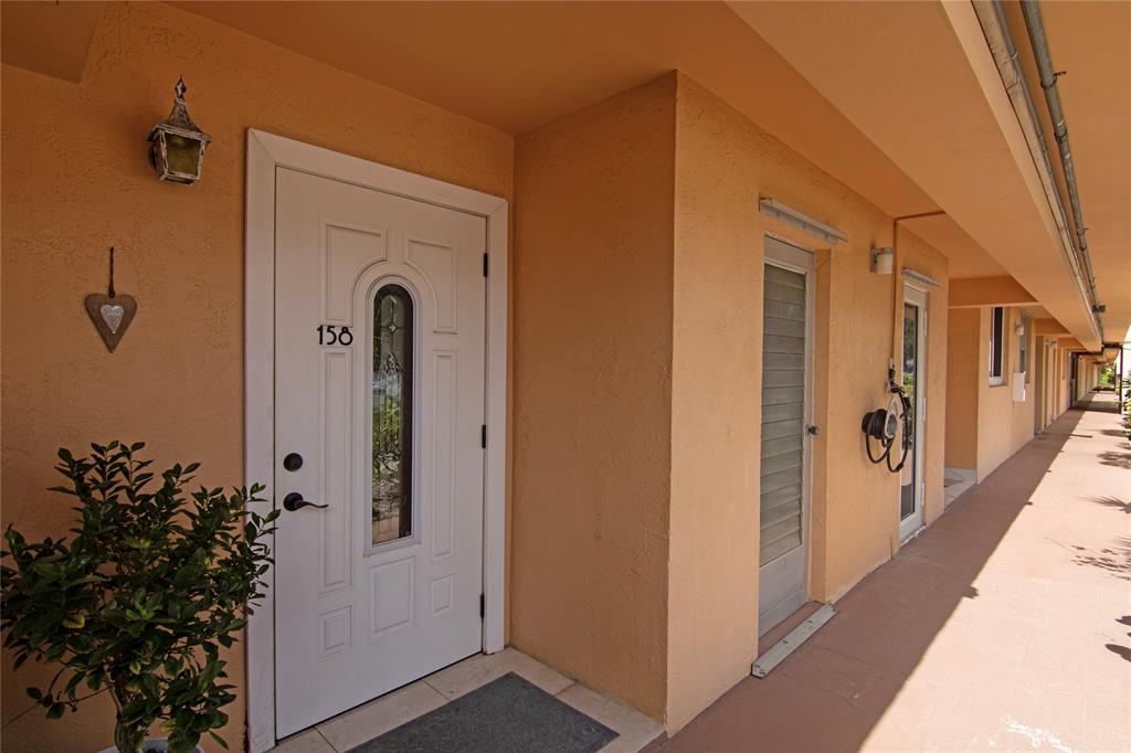4500 North Federal Highway, Unit 158G Lighthouse Point, FL 33064 - Photo 18 of 36 a view of a front door and porch