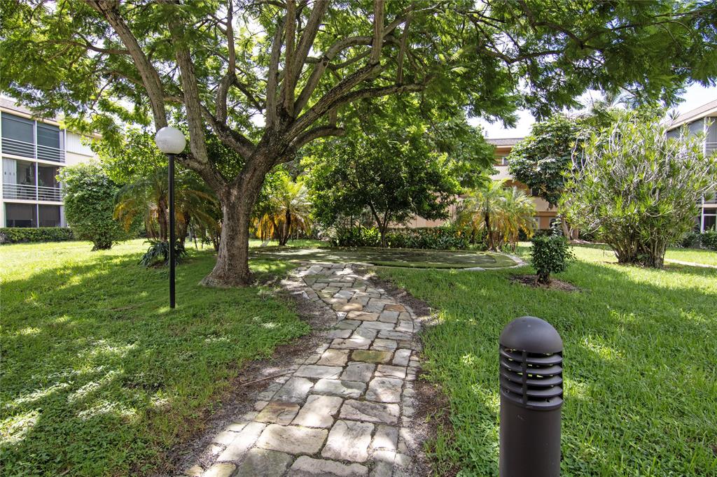 4500 North Federal Highway, Unit 158G Lighthouse Point, FL 33064 - Photo 29 of 36 a backyard of a house with lots of green space and fountain
