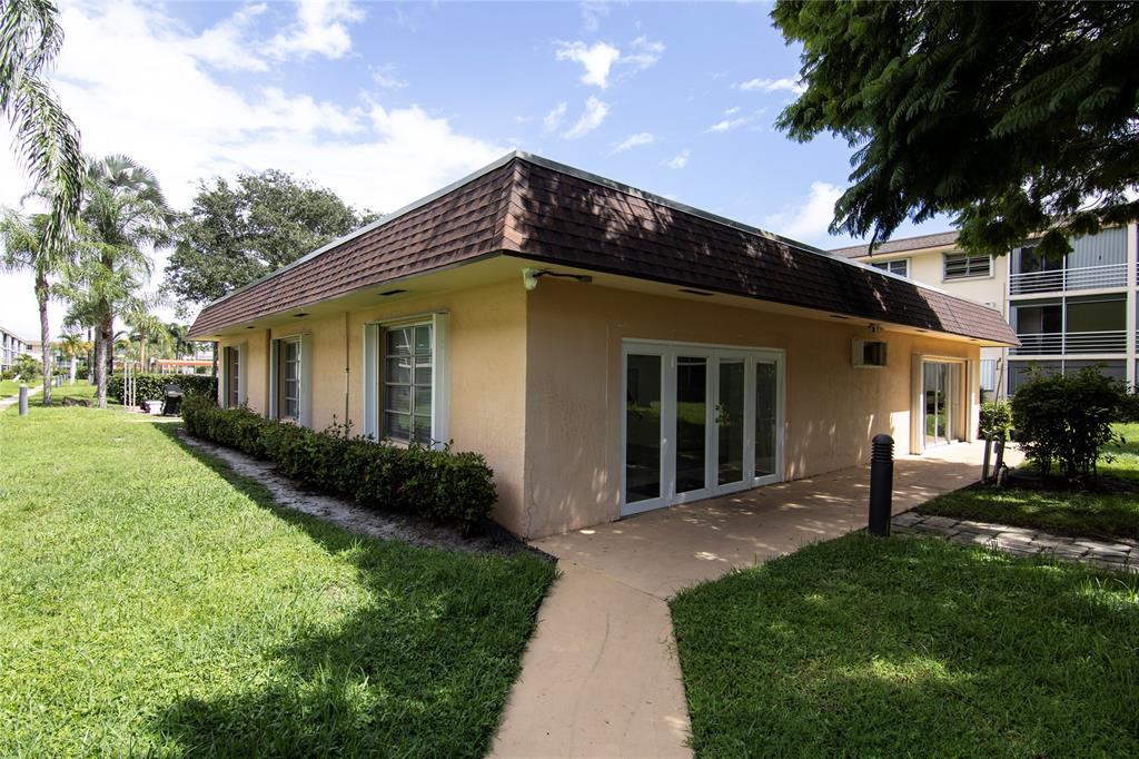 4500 North Federal Highway, Unit 158G Lighthouse Point, FL 33064 - Photo 30 of 36 a view of a house with a yard plants and large tree