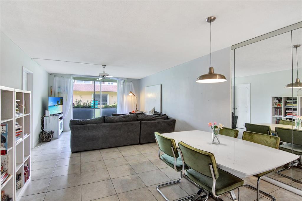 4500 North Federal Highway, Unit 158G Lighthouse Point, FL 33064 - Photo 6 of 36 a kitchen with a table and chairs in it