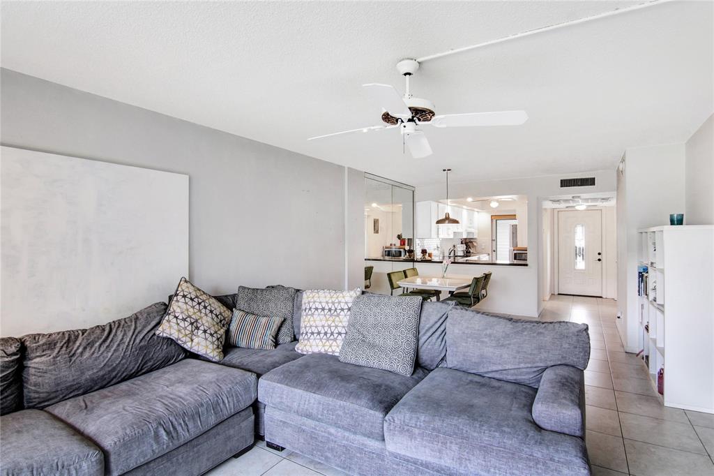 4500 North Federal Highway, Unit 158G Lighthouse Point, FL 33064 - Photo 7 of 36 a living room with furniture and kitchen view