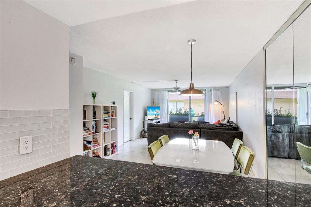 4500 North Federal Highway, Unit 158G Lighthouse Point, FL 33064 - Photo 8 of 36 a living room with furniture a rug and a chandelier