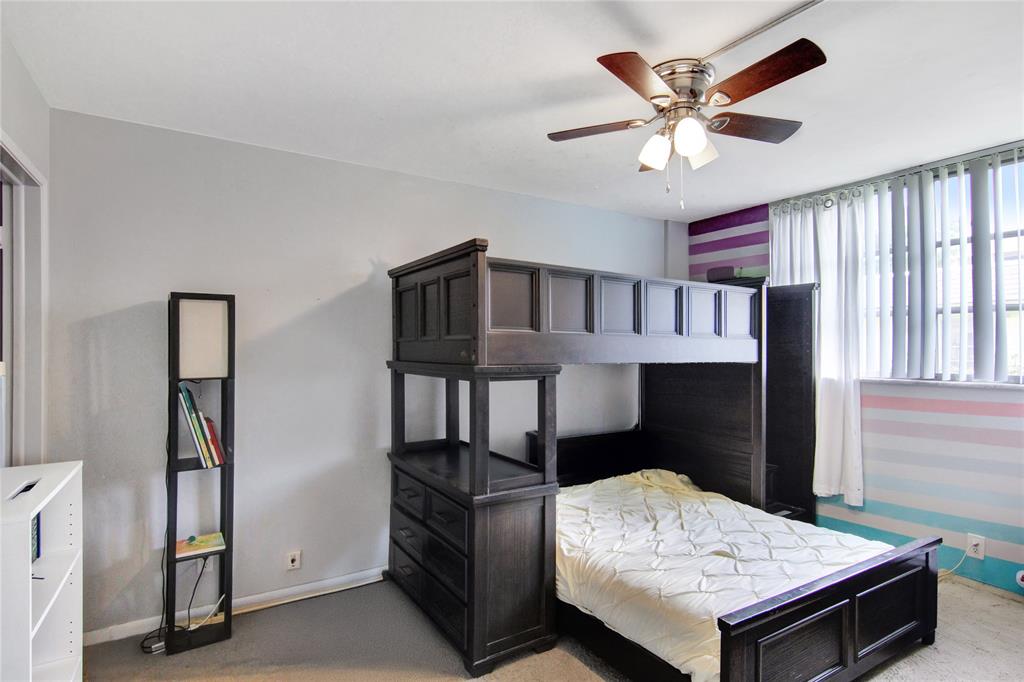 4500 North Federal Highway, Unit 158G Lighthouse Point, FL 33064 - Photo 10 of 36 a bedroom with a bed and a chandelier