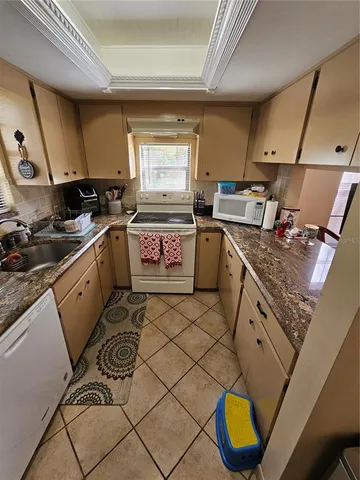 a kitchen with a sink appliances and cabinets