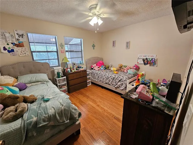 a bedroom with furniture and a wooden floor