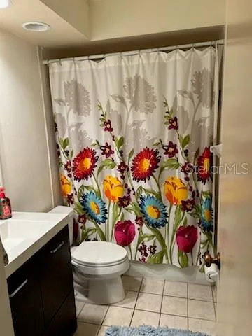 a bathroom with a sink mirror vanity and toilet