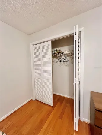 an empty room with a gallery and wooden floor