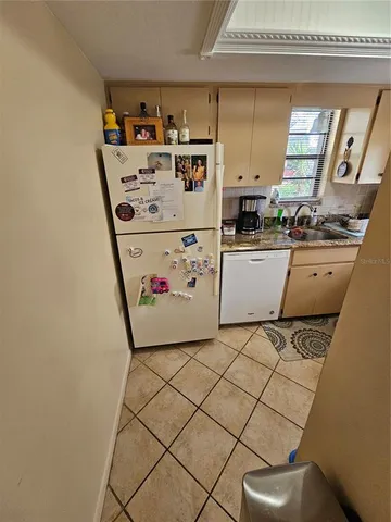 a refrigerator freezer sitting inside of a kitchen