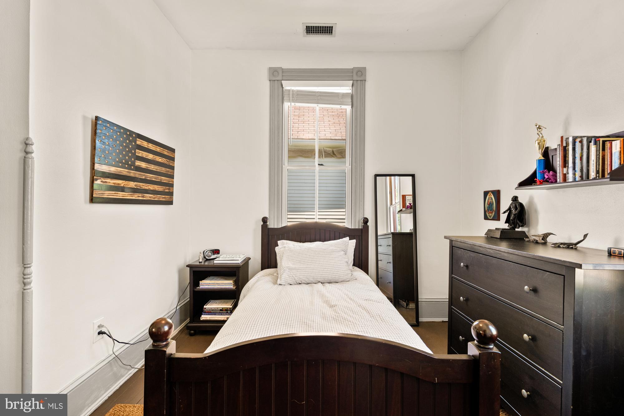 4916 40th Place Hyattsville, MD 20781 - Photo 32 of 48 a bedroom with a bed and a bookshelf