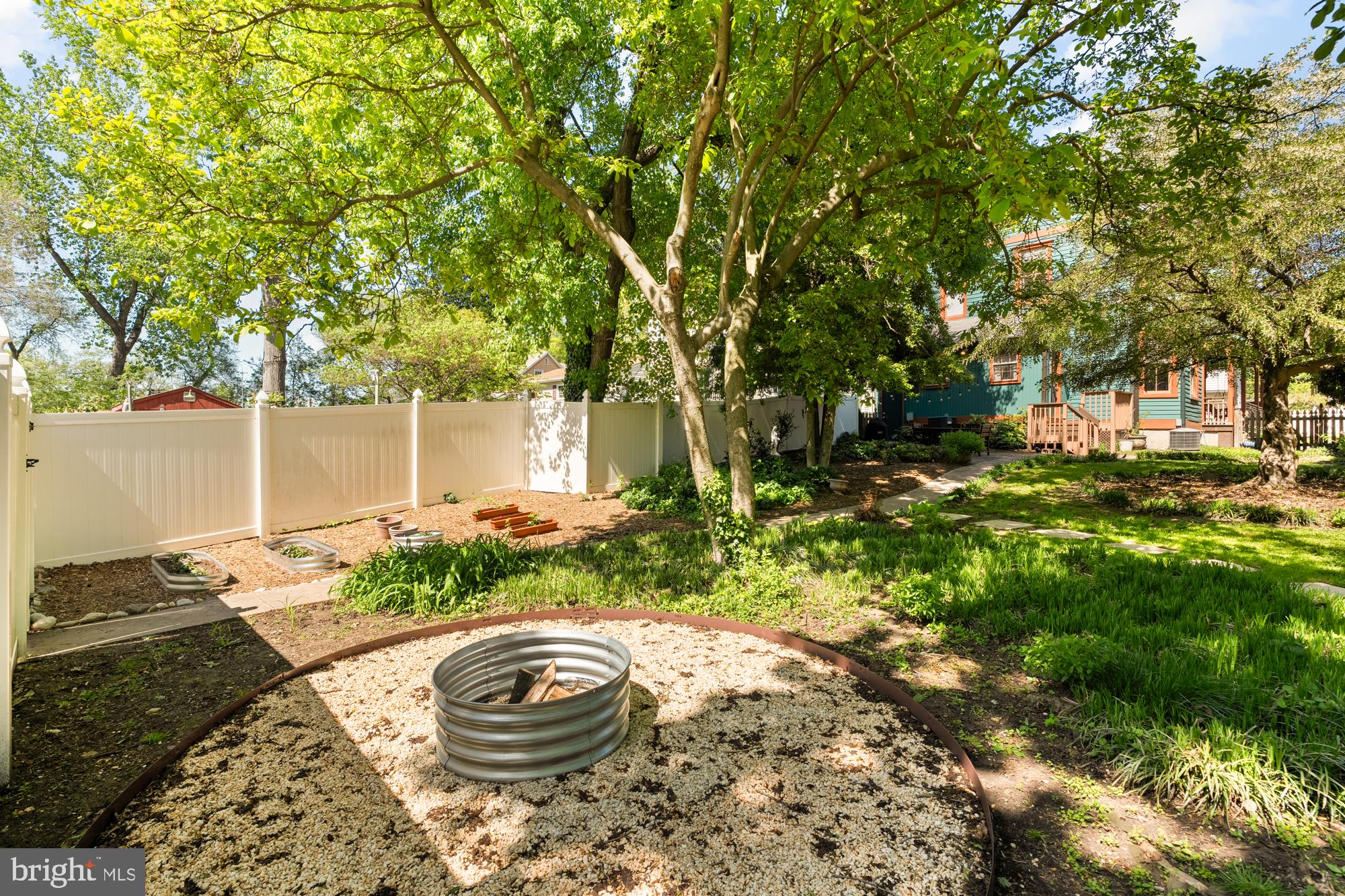 4916 40th Place Hyattsville, MD 20781 - Photo 44 of 48 a backyard of a house with table and chairs and wooden fence