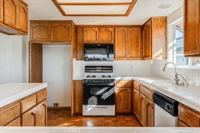 a kitchen with a stove a sink and a microwave