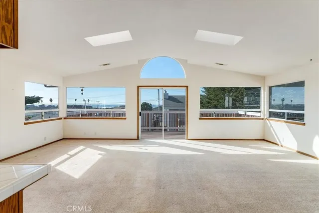 a view of an empty room with a kitchen