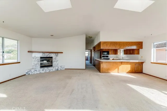 a view of a kitchen with a sink a fireplace and a large window