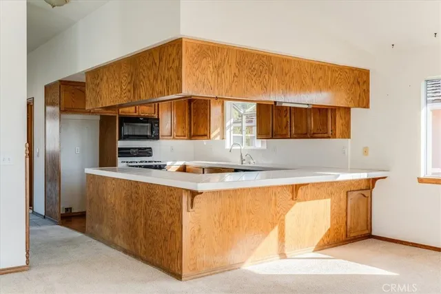 a kitchen with stainless steel appliances a sink and a refrigerator