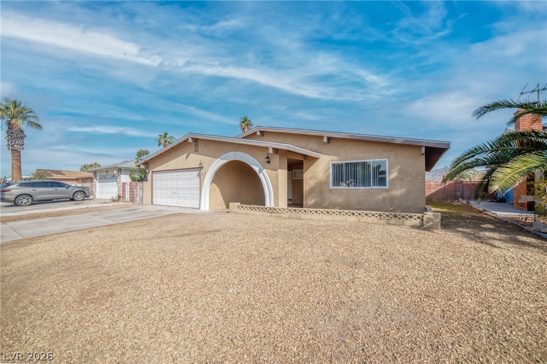 3556 Ruth Drive Las Vegas, NV 89121 - Photo 3 of 21 A desert oasis with an inviting archway leading to the entrance and a practical garage.