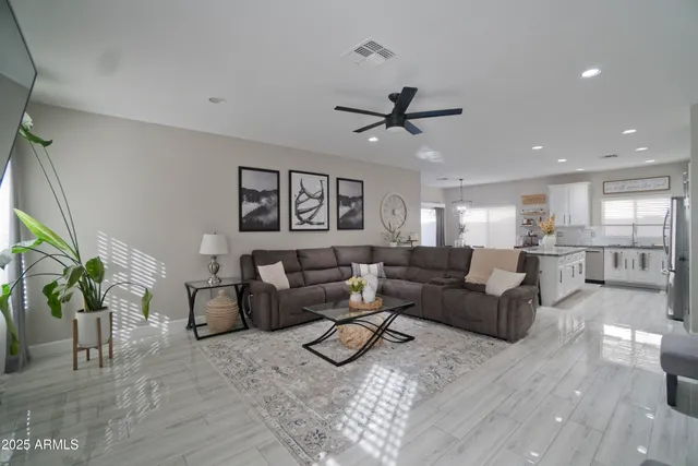 a living room with furniture and a wooden floor