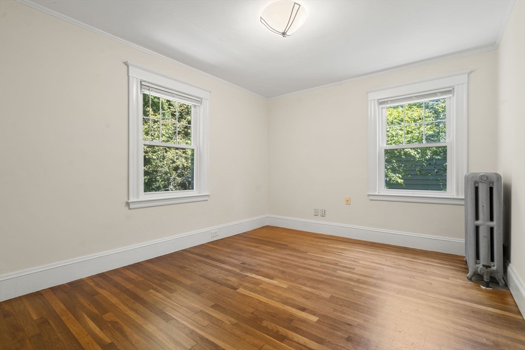 34 Westminster Road Newton, MA 02459 - Photo 13 of 40 an empty room with wooden floor and windows