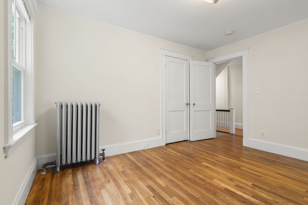 34 Westminster Road Newton, MA 02459 - Photo 14 of 40 an empty room with wooden floor and a window