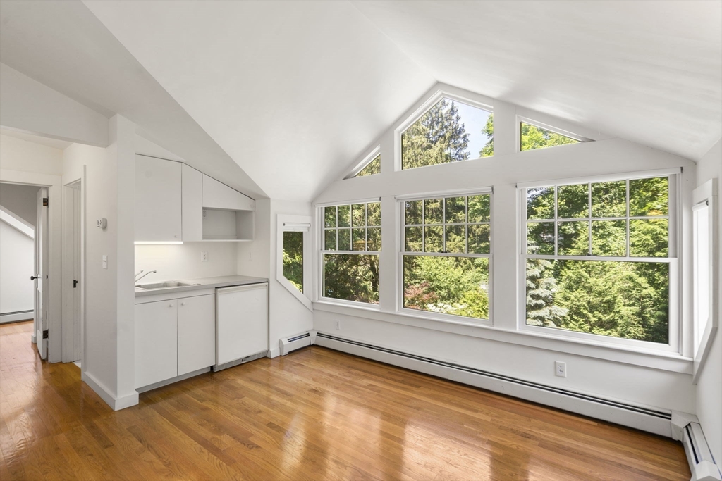 34 Westminster Road Newton, MA 02459 - Photo 18 of 40 a view of an empty room with a window and wooden floor