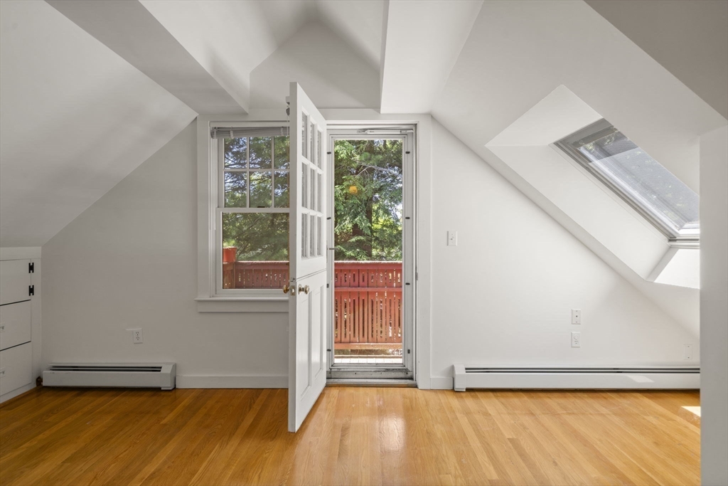 34 Westminster Road Newton, MA 02459 - Photo 23 of 40 a view of an empty room with a window and wooden floor