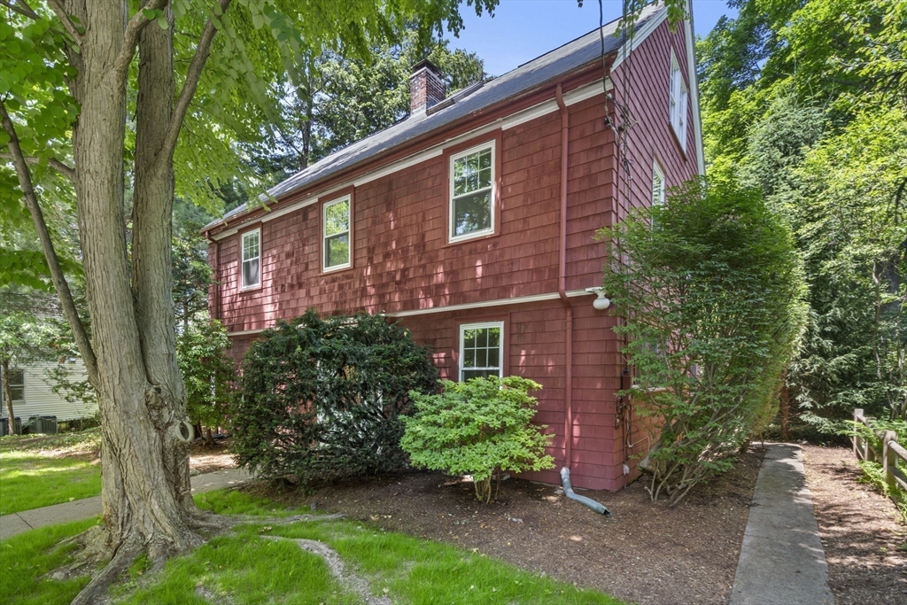 34 Westminster Road Newton, MA 02459 - Photo 34 of 40 a view of a brick house with a yard plants and large tree