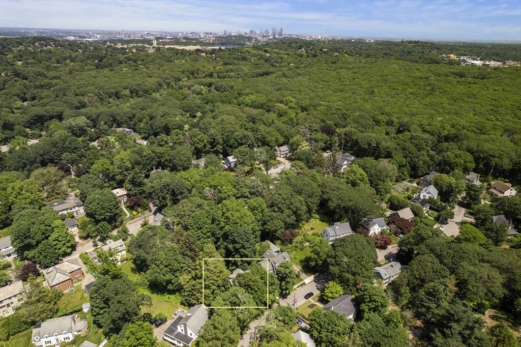 34 Westminster Road Newton, MA 02459 - Photo 36 of 40 an aerial view of a houses with a lush green hillside
