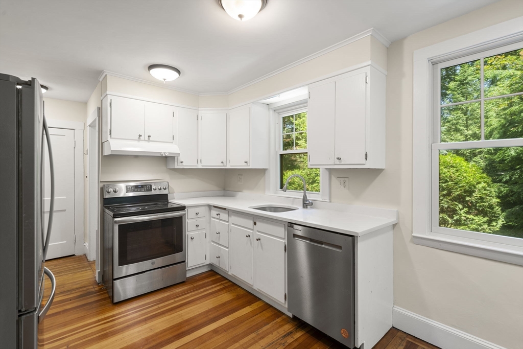 34 Westminster Road Newton, MA 02459 - Photo 8 of 40 a kitchen with stainless steel appliances granite countertop a stove a sink and a refrigerator