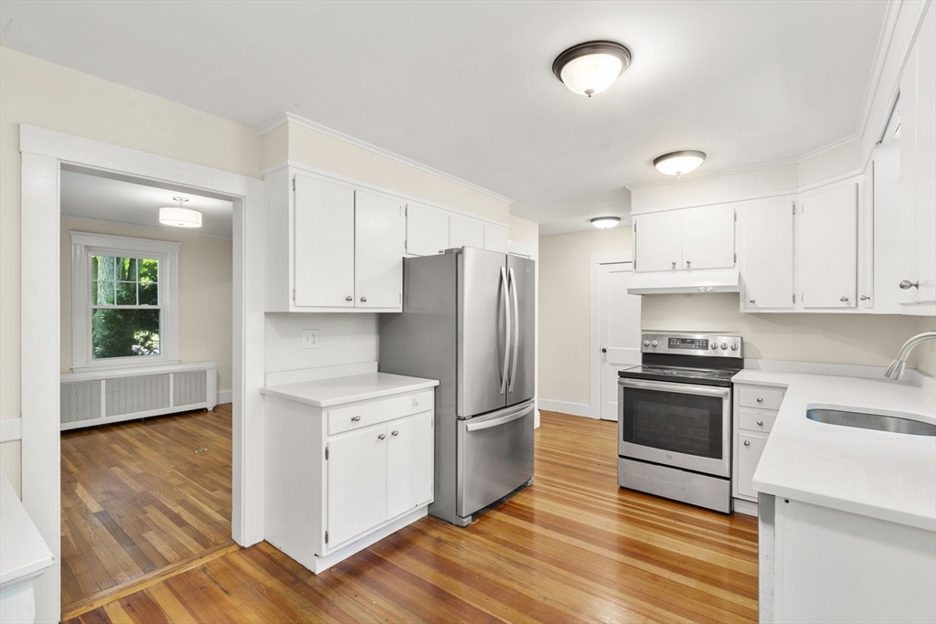 34 Westminster Road Newton, MA 02459 - Photo 9 of 40 a kitchen with granite countertop a refrigerator and a stove top oven