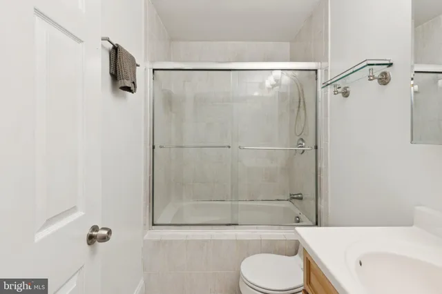 a bathroom with a shower toilet and a sink
