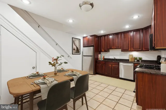a kitchen with granite countertop a sink stainless steel appliances and cabinets