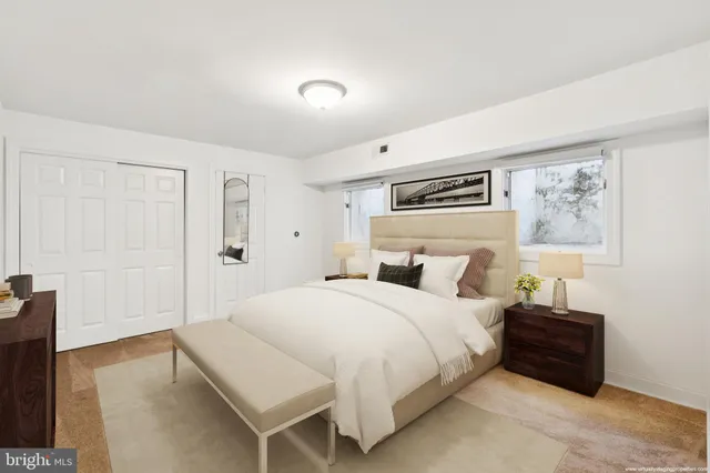 a bedroom with a bed and a painting on the wall