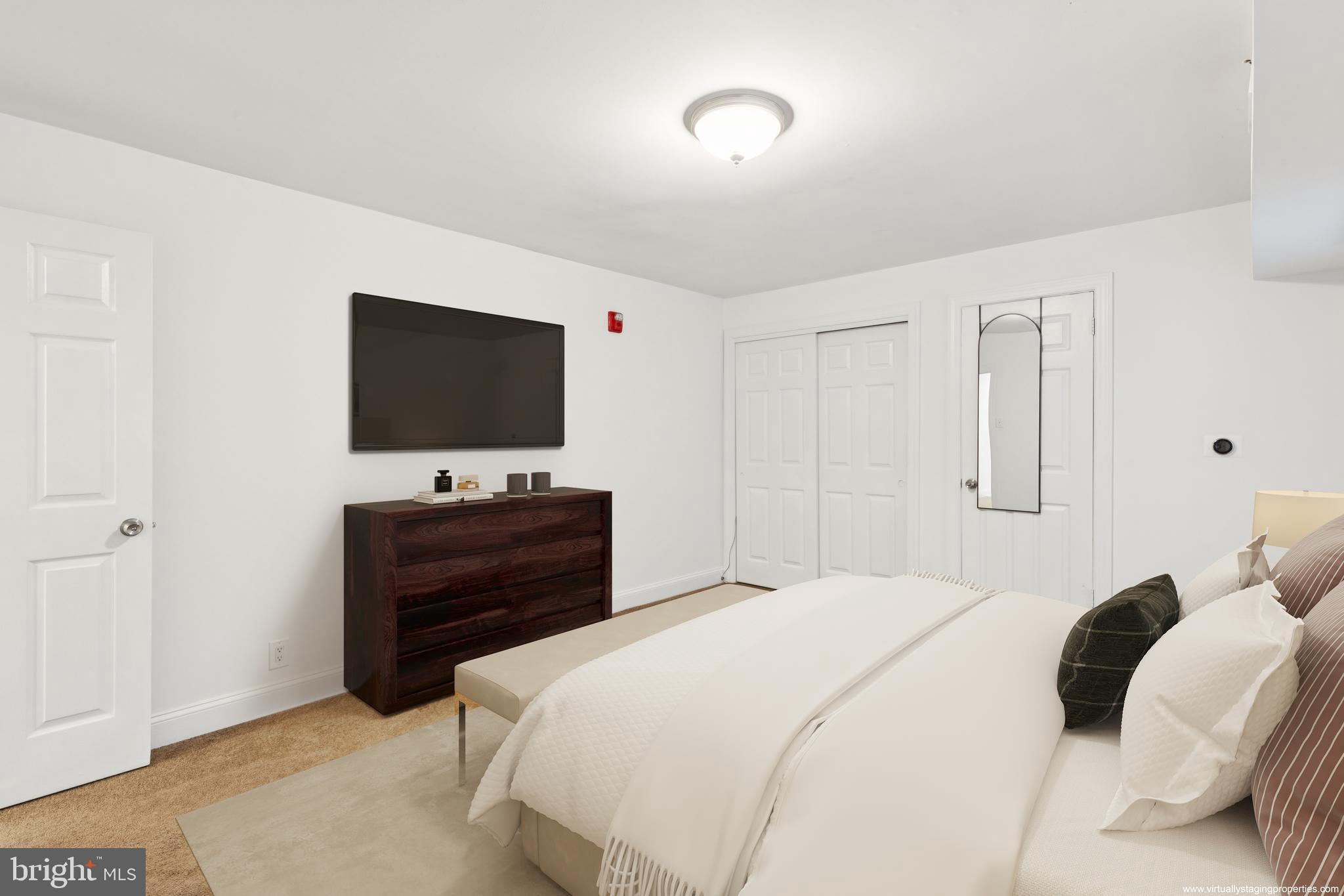 1232 South Street, Unit A Philadelphia, PA 19147 - Photo 19 of 27 a bedroom with a bed and a flat screen tv