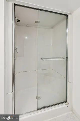 a bathroom with a glass shower door