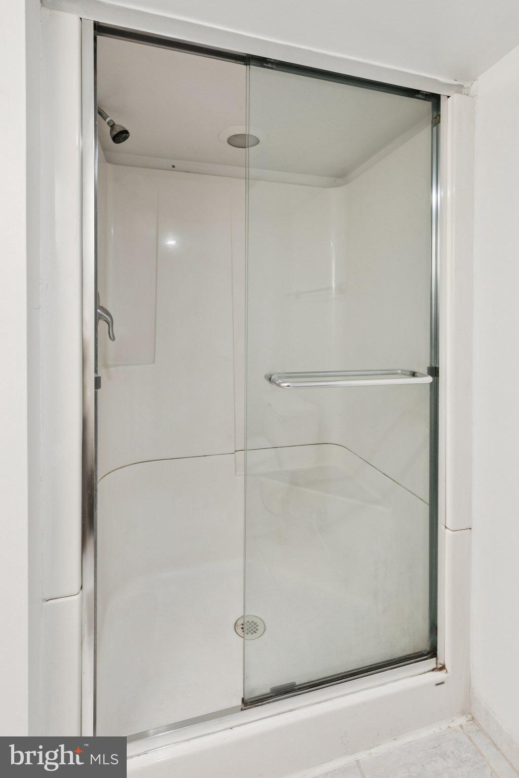 1232 South Street, Unit A Philadelphia, PA 19147 - Photo 23 of 27 a bathroom with a glass shower door