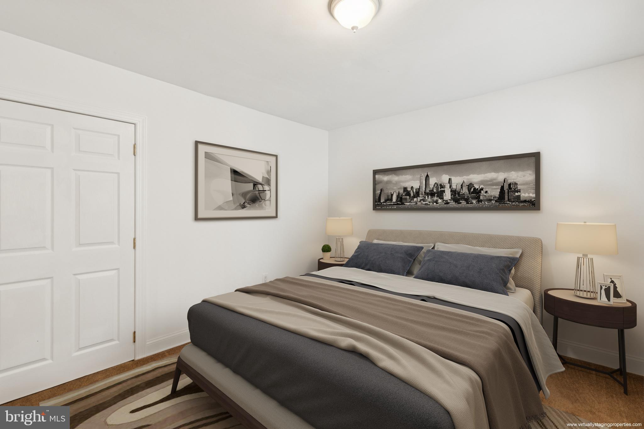 1232 South Street, Unit A Philadelphia, PA 19147 - Photo 8 of 27 a bedroom with a large bed and a lamp on table