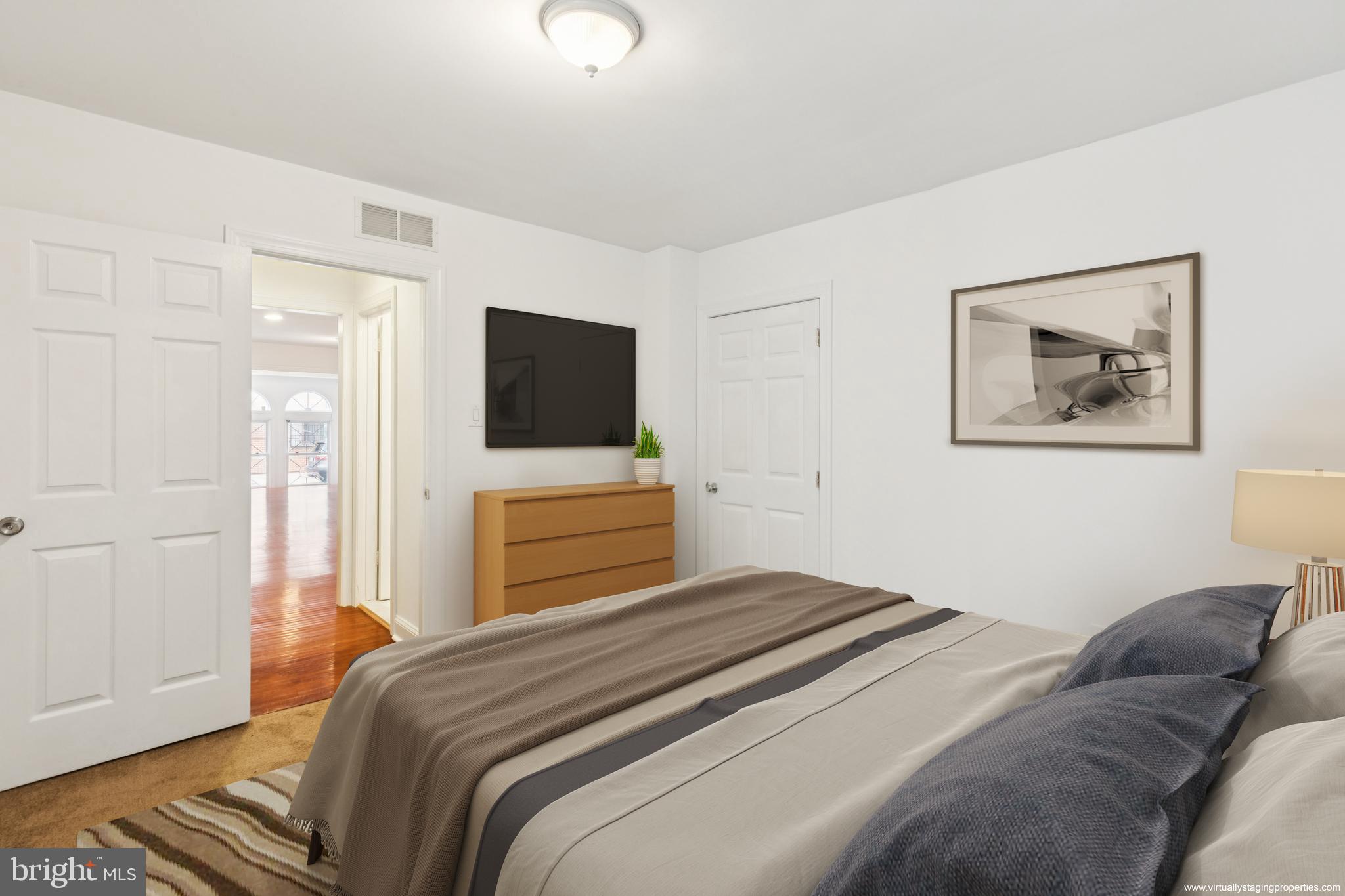1232 South Street, Unit A Philadelphia, PA 19147 - Photo 9 of 27 a bedroom with a bed and a flat screen tv