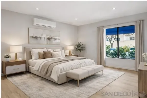 a spacious bedroom with a bed and a window