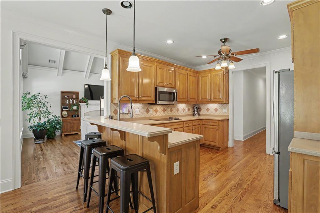 537 Old Collins Road Hoschton, GA 30548 - Photo 13 of 42 a kitchen with kitchen island a dining table chairs sink and wooden floor