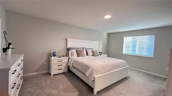 a bed room with a bed and a window