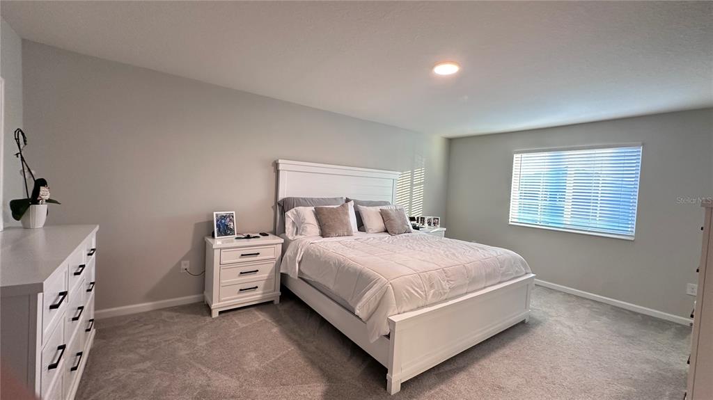 4424 Campsite Loop Orlando, FL 32824 - Photo 13 of 40 a bed room with a bed and a window