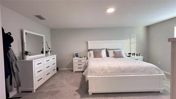 a room with a bed and a mirror