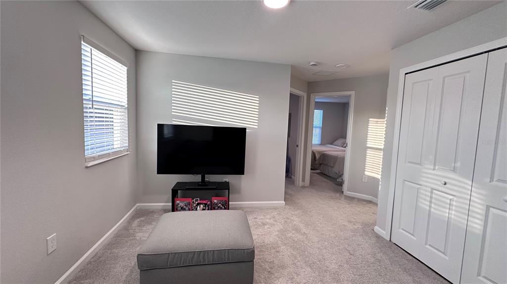 4424 Campsite Loop Orlando, FL 32824 - Photo 18 of 40 a living room with furniture and a flat screen tv