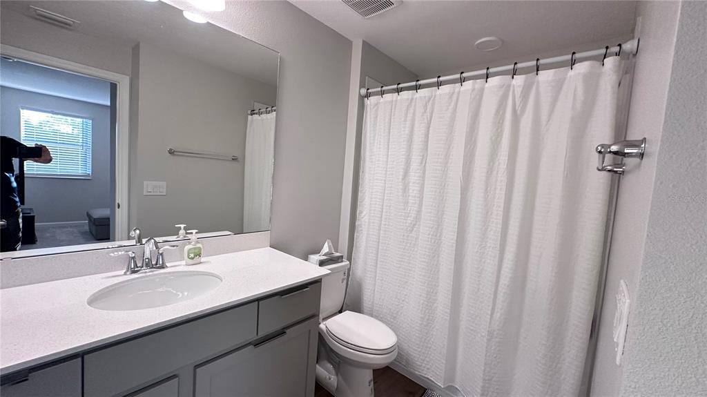 4424 Campsite Loop Orlando, FL 32824 - Photo 22 of 40 a bathroom with a sink and a toilet