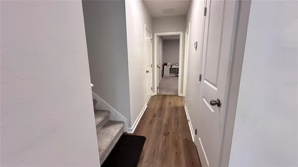 a view of a hallway with a wooden floor