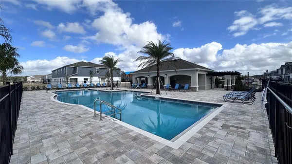 a view of a house with swimming pool and sitting area