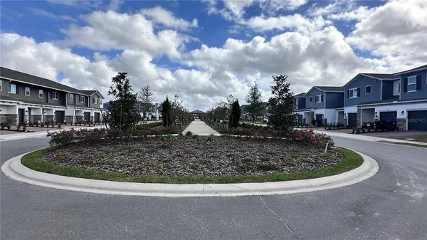 a view of the house that has a fountain